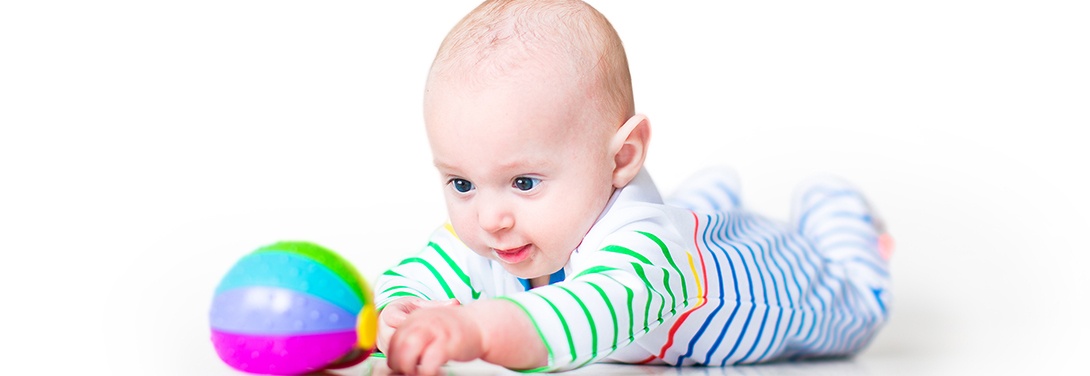 Baby reaching for a ball