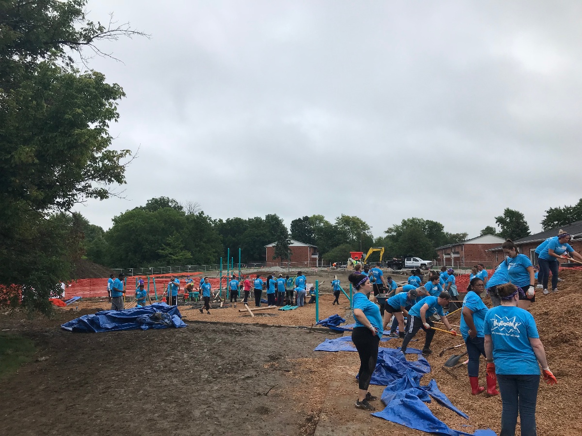 Volunteers help build the Carriage House East playgroun