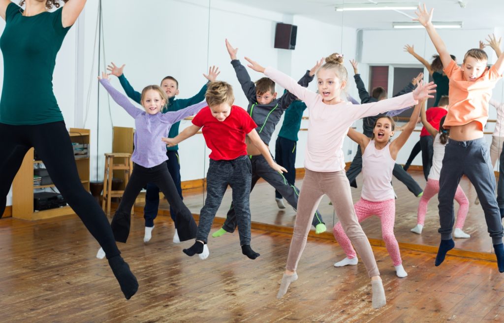 Young children dancing and jumping