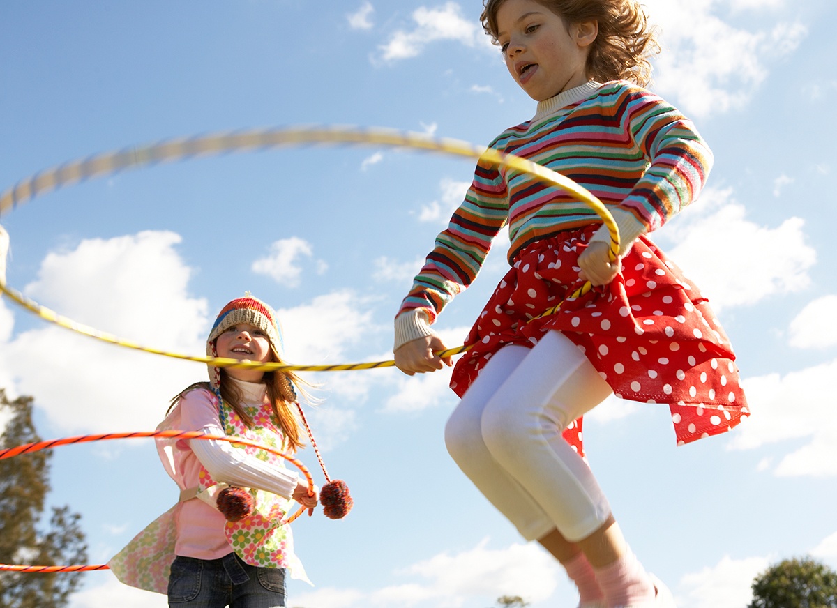Girls jump with hula hoops