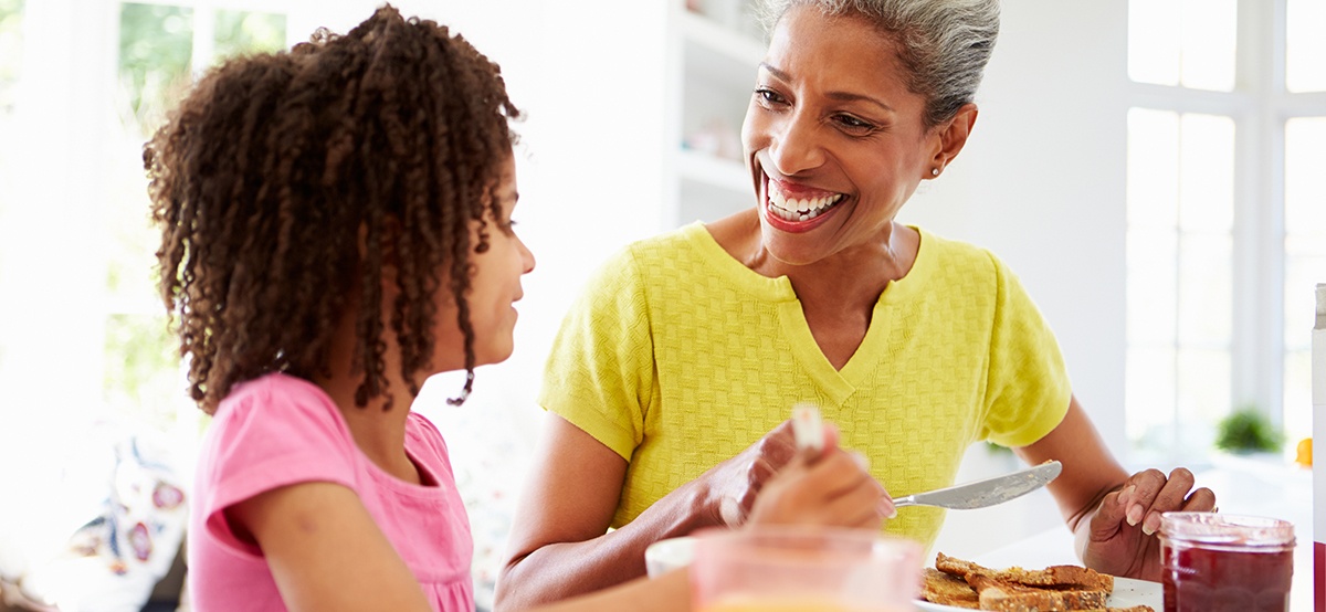 Grandmother and granddaughter eating