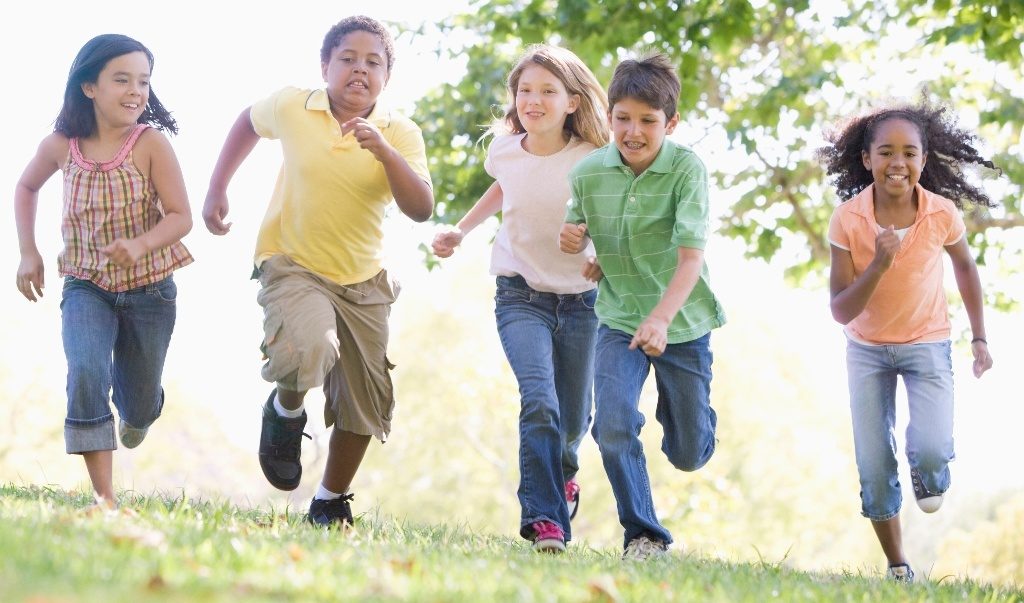 Kids running outside in a group