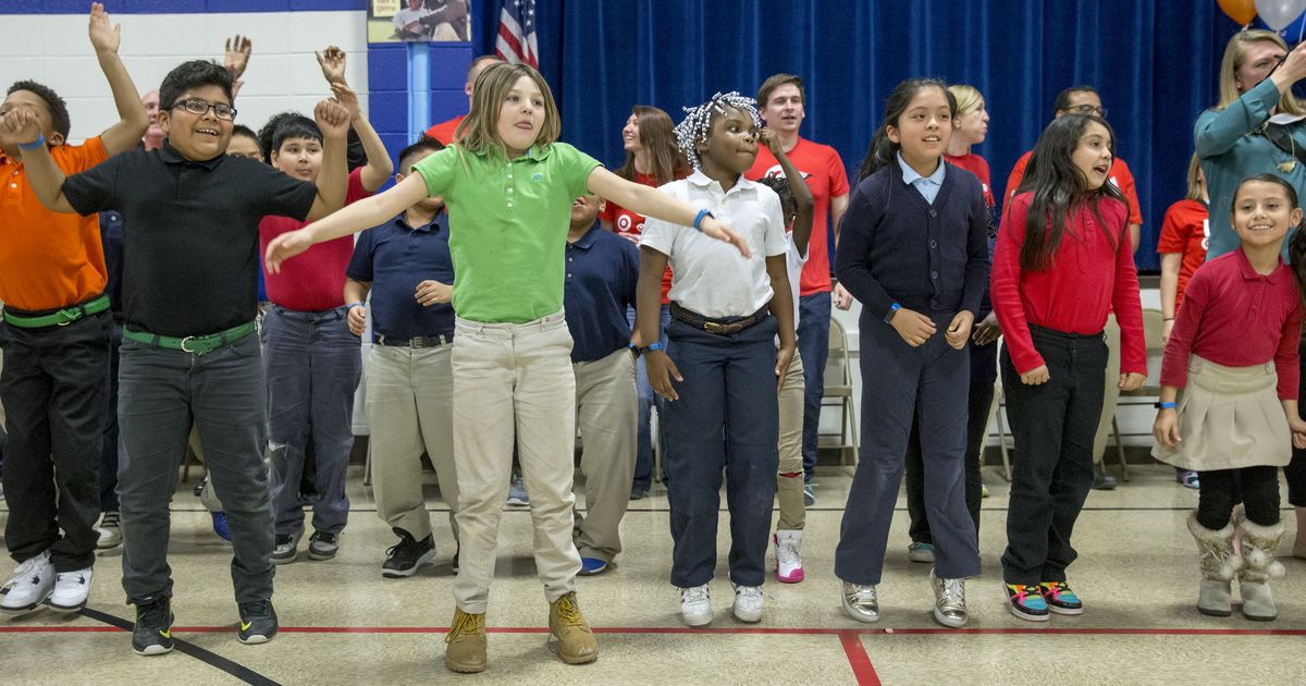 Kids jump and move during an assembly