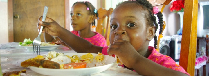 Girls eat lunch in a home child care