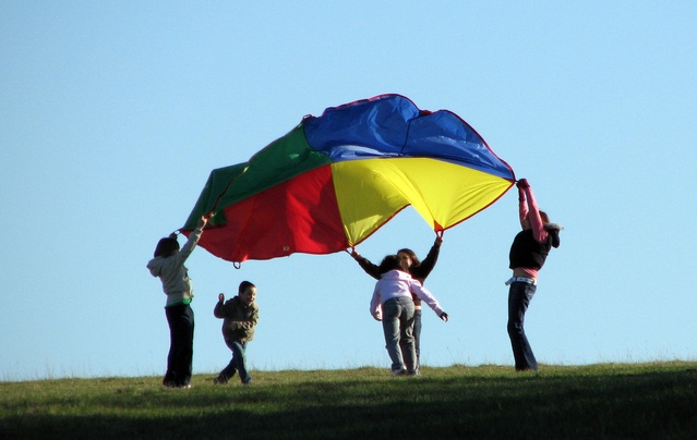 Kids playing with a parachute outdoors