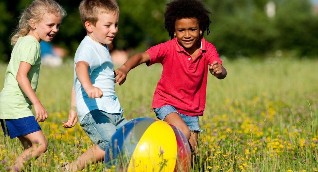 Preschool children playing in a field