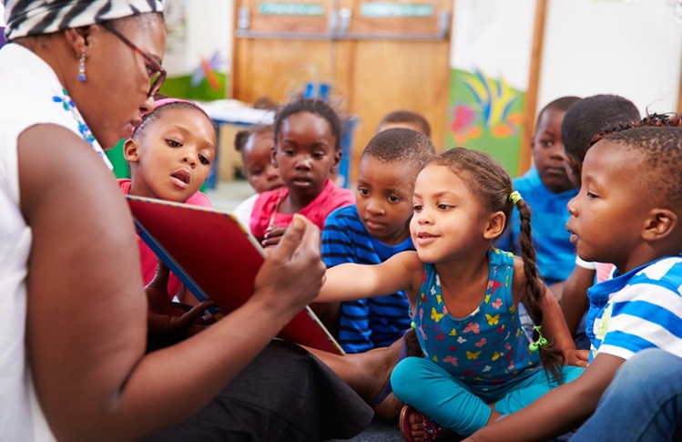 A teacher reads to preschool students