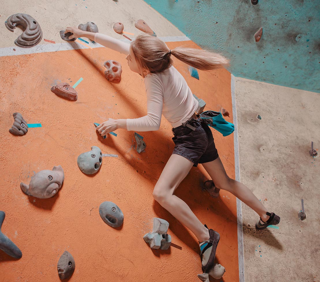 Girl climbing on a wall