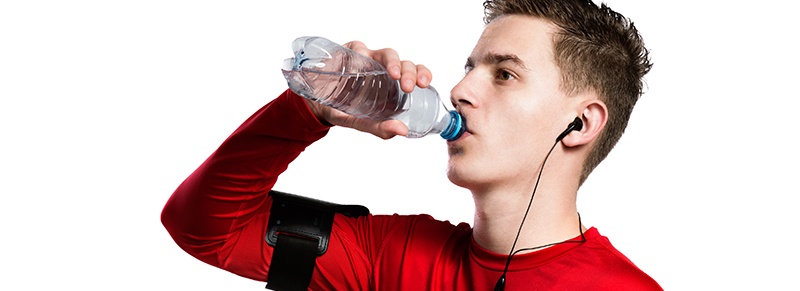 Teen athlete drinking water
