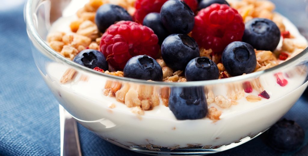 Yogurt, granola, and fruit in a bowl