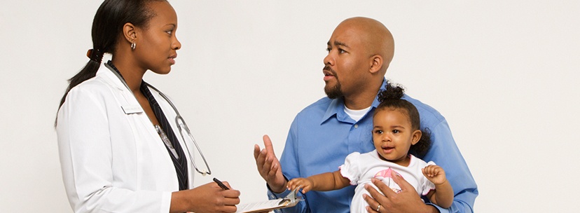 Pediatrician with dad and daughter