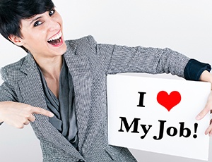 Woman holding a sign that says, "I love my job"