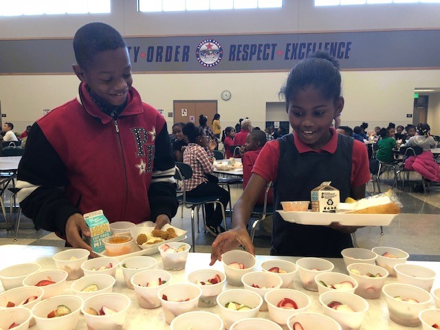 Kids sample radishes at their Rah Rah Radish day, a day planned to inspire kids to try new foods