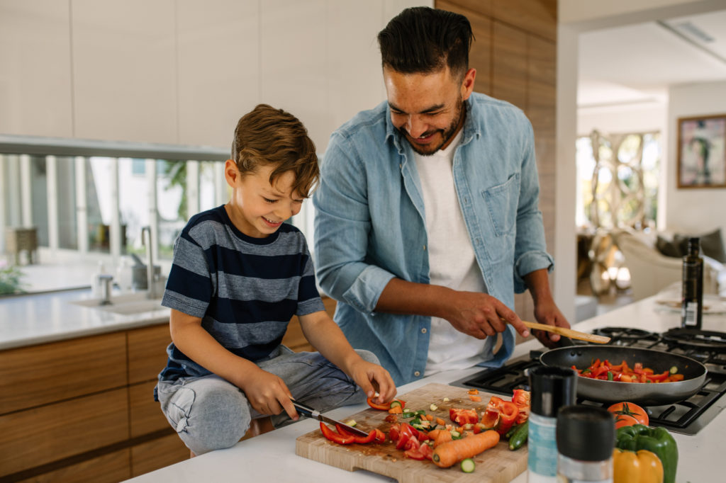 Father and son cook together in the kitchen