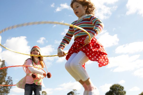 Girls hula hooping outdoors