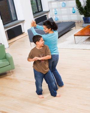 Boy and mom dancing in their living room
