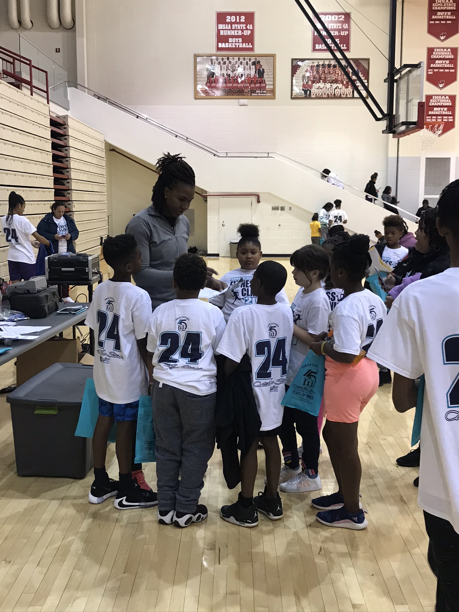 Tamika Catchings advises a group of students at her Fitness Clinic