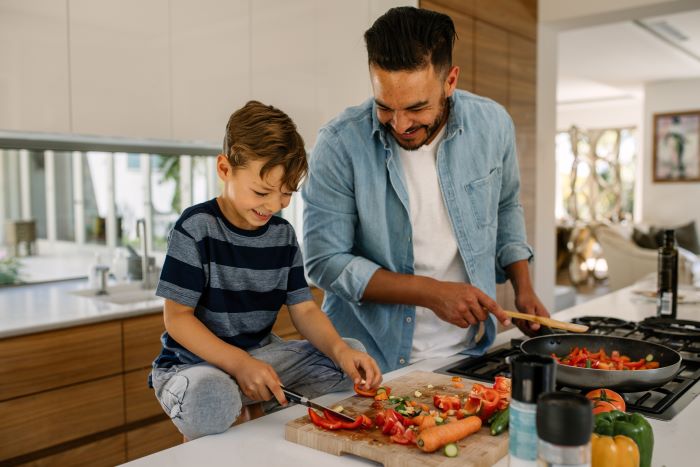 Dad and son cook together