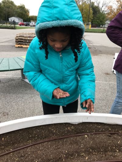 Student learning to plant seeds
