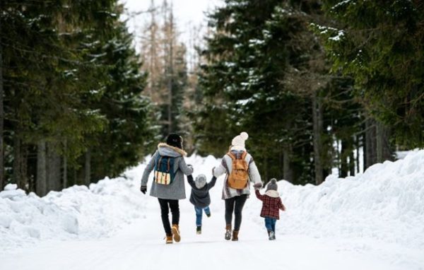 Family hikes on a beautiful, snowy trail
